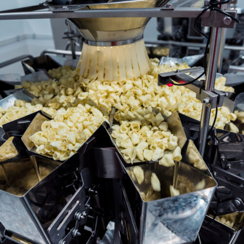 Vertical multi-head weigher packaging machine snacks and chips in a factory Vertical multi-head weigher packaging machine snacks and chips in a factory.